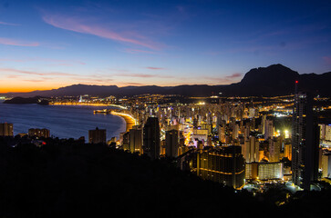 Benidorm, Costa Blanca, Spain at sunset in summer time with a few clouds
