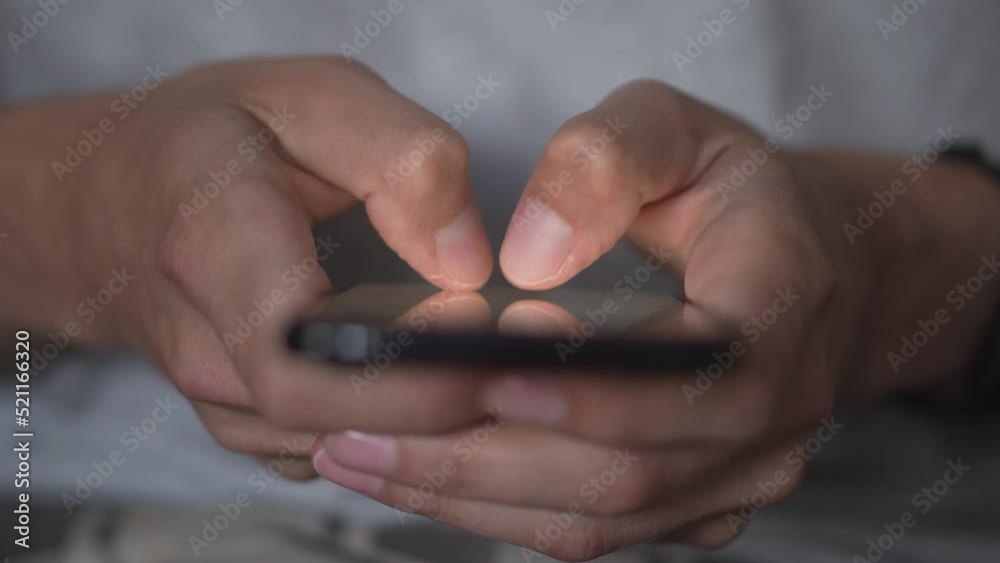 Leinwandbilder A young man uses a smartphone to write and send a message, close-up. Keep your cell phone in your hand. Mobile Tech 5g concept and people exchanging and reading sms on display. Browse and receive.