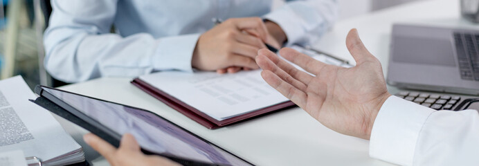 Business brainstorming, Marketers and conference leaders on business plans and marketing strategies using tablet for data analysis, Using business data graphs in meetings.