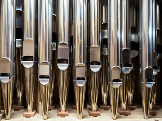 modern steel organ pipes, structure of organ, musical instrument. close up view inside of musical...