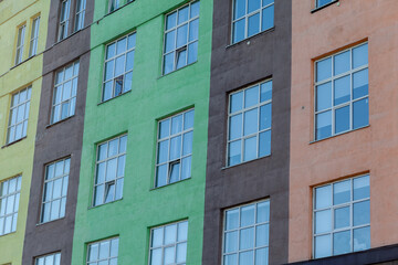 The exterior of a tall building with windows. A newly built building for offices and housing.