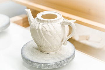 Porcelain tea pot, dry on pallet before glazing and firing.