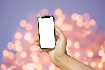 Mobile phone with empty white screen in hand on bright bokeh background