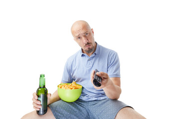 Fototapeta premium Adult man with beer and chips watching tv isolated on white background.