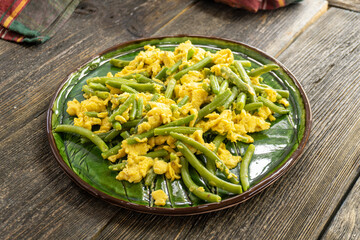 green asparagus with scrambled eggs on a plate. food concept.