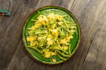 green asparagus with scrambled eggs on a plate. food concept.