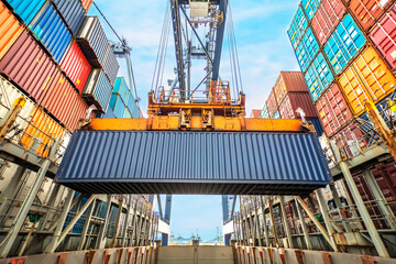 Industrial crane loading Containers in a Cargo freight ship. Container ship in import and export...