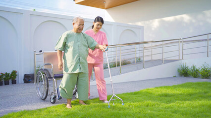 Old elderly Asian patient or pensioner people walking by walker with a nurse, relaxing, in nursing...