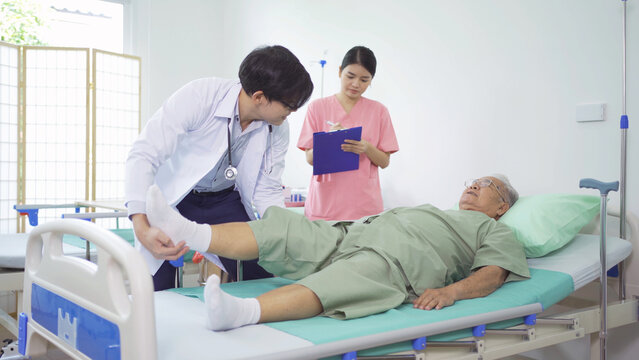 Old Elderly Asian Patient Or Pensioner, A Nurse And A Doctor Smiling, Doing Exercise, Working Out  In Nursing Home In Hospital.Senior People Lifestyle Activity Recreation. Health Care Physical Therapy