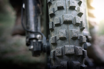 Close up motocross wheel on a mound road. copyspace for your individual text.