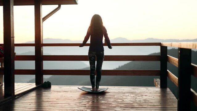Active girl training in mountains, making yoga pose. Motivation. Active lifestyle.