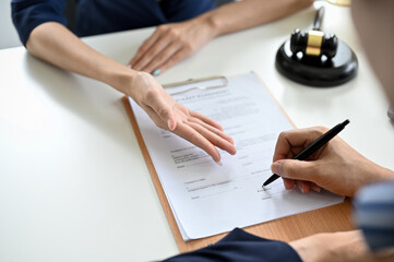 Cropped, A male client sign his signature on a contract agreement paper