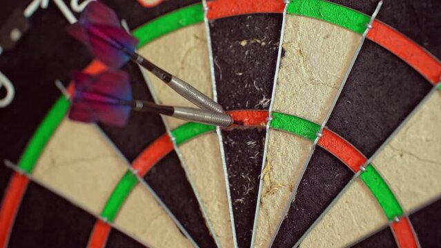 A dart is thrown to complete a 180 score.