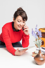 A hispanic woman using phone at office