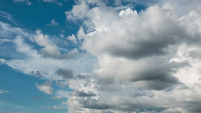 Beautiful white clouds on blue sky background. Ultra HD 4k time lapse footage.