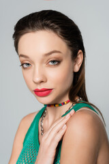 close up view of stylish woman with red lips posing isolated on grey