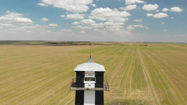 Flight in a field near alone lighthouse. Hublov lighthouse in Ukraine.