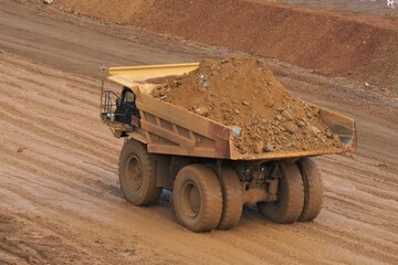 A haul truck is transporting material at a nickel mine site. Rigid dump trucks specifically...