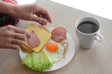 Woman preparing tasty nutritious breakfast at wooden table against white background, closeup. Good morning