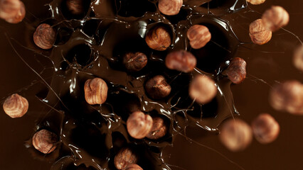 Freeze motion of falling hazelnuts into melted chocolate.