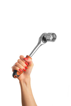 Woman's hand with a red manicure and a wrench wheel on an isolated white background. Concept gender equality.