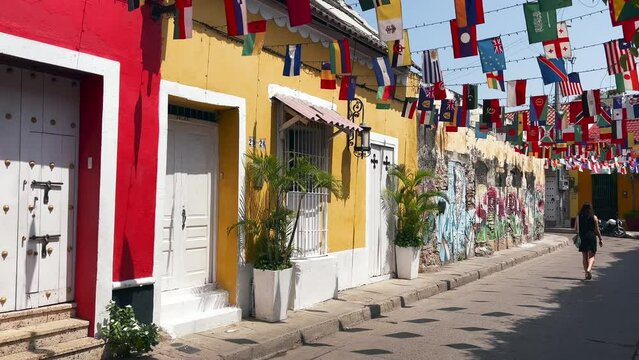 Cartagena - Colombia - View of girl walking in a colorful street full of flags