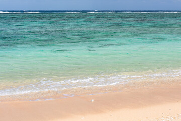 Turquoise crystal clear water at seashore in a sunny day.