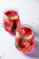 Raspberry lemonade drink on white marble