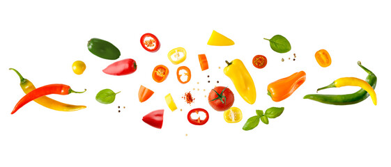 Mediterranean healthy food, vegetarian ingredients  flying isolated on white. Cherry and cocktail tomatoes, basil, colorful chilli and mini bell pepper whole and sliced.