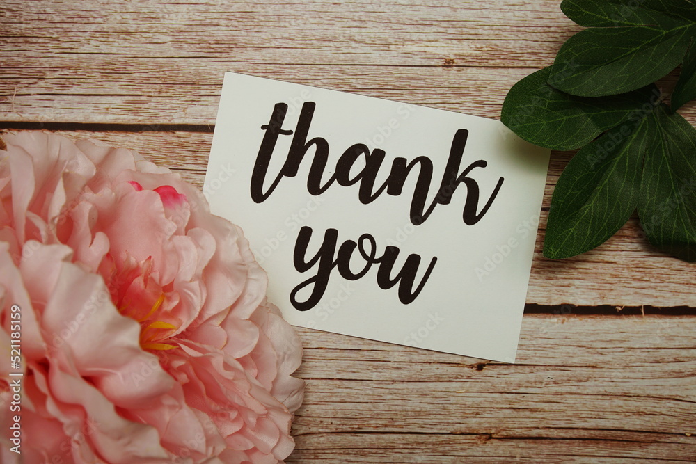 Sticker Thank You typography text with flower decorated on wooden background