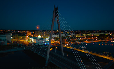 Aerial view of the Millennium Bridge at night with a full moon backdrop in Southport Merseyside