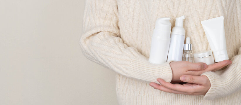 Skincare daily routine for healthy skin. Woman hands holding skincare product set included facial foam, cleanser, serum, moisturizer cream and body lotion packaging. Beauty and cosmetic concept.