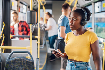 African american woman using smartphone while riding a bus
