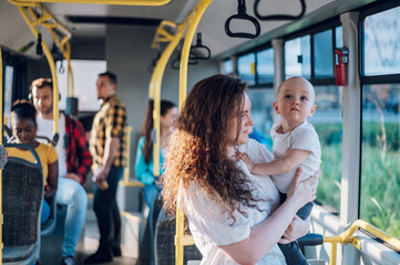 Mother and a baby riding in a bus in the city © Zamrznuti tonovi
