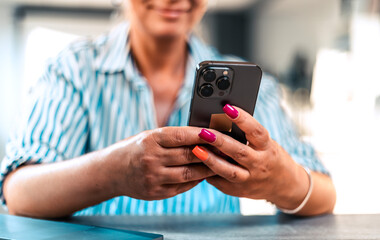 Hand of woman using smartphone, Space for text or design..