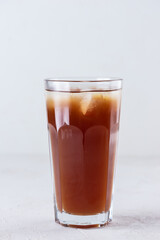 Non-alcoholic drink in a glass on a light background.