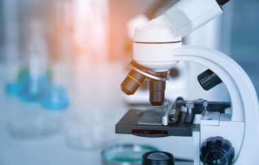 Laboratory research, microscope with lab glassware, science laboratory research and development concept.
