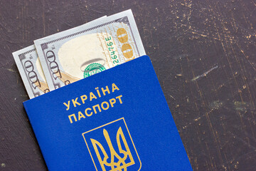 Ukrainian passport and several dollar bills. Fight against corruption in Ukraine. Anti-corruption laws in Ukraine. Ukrainian corruption.