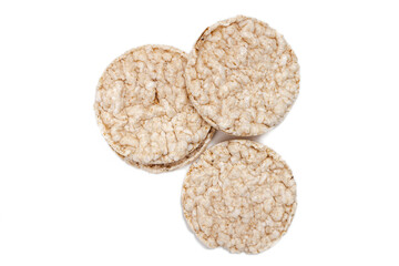 Exquisite round rice crackers on a white surface. Copy Space. Healthy eating.