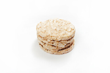 Exquisite stack of round rice crackers on a white surface. Copy Space. Healthy eating.