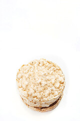 Exquisite stack of round rice crackers on a white surface. Copy Space. Healthy eating.