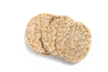 Exquisite round rice crackers on a white surface. Copy Space. Healthy eating.