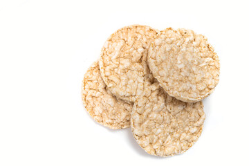 Exquisite round rice crackers on a white surface. Copy Space. Healthy eating.