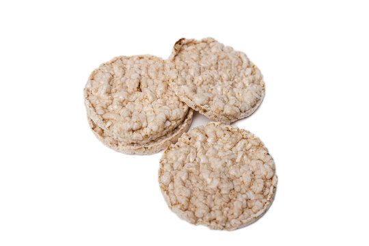 Exquisite round rice crackers on a white surface. Copy Space. Healthy eating.