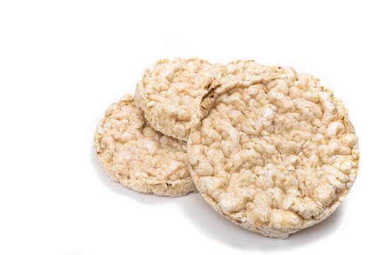 Exquisite round rice crackers on a white surface. Copy Space. Healthy eating.