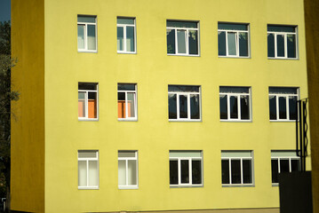 Fototapeta premium bright school building kindergarten green yellow school background windows minimalism in Ukraine in Kyiv