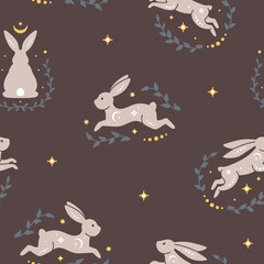 Obraz premium Trendy celestial seamless pattern with rabbits. Boho magic background with nature and space elements, leaves, moon, stars and rabbits. Design for card, fabric, print, greeting, poster. Vector