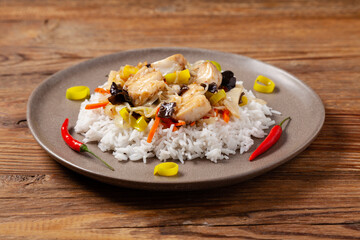Chinese style cod, served on a plate with white rice.