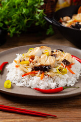 Chinese style cod, served on a plate with white rice.