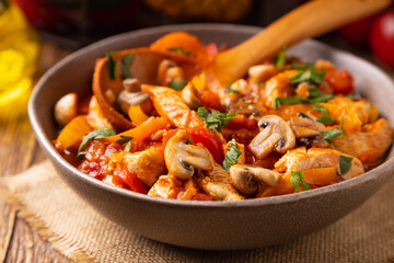 Chicken stew with peppers, mushrooms and tomatoes.